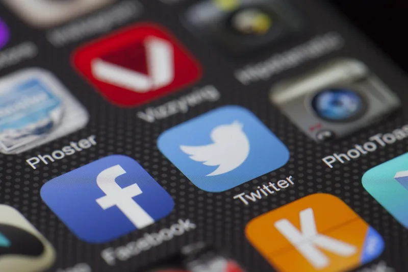Threads and Twitter X logos side by side with a comparison layout for creators in 2026