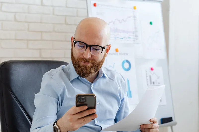 Business owner reviewing Page analytics and cover photo options on a phone