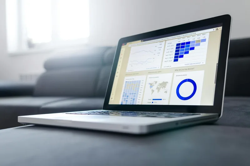Clean analytics dashboard on a laptop screen showing subscriber growth metrics and email open rate trends
