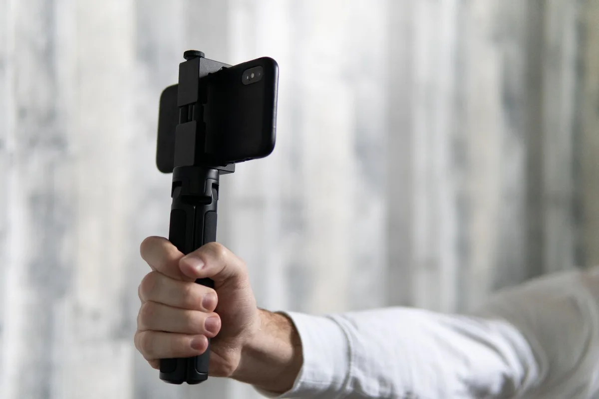 Smartphone on a tripod filming a vertical video.