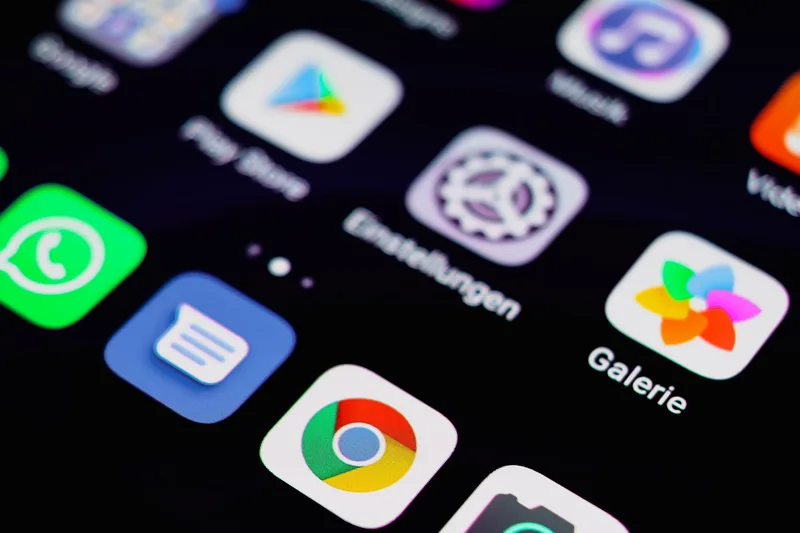 Close-up of a smartphone screen displaying app icons, representing the YouTube mobile upload flow