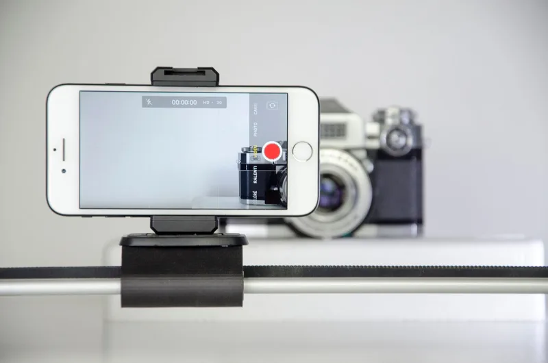 Close-up of a smartphone recording video, used to check vertical framing before uploading