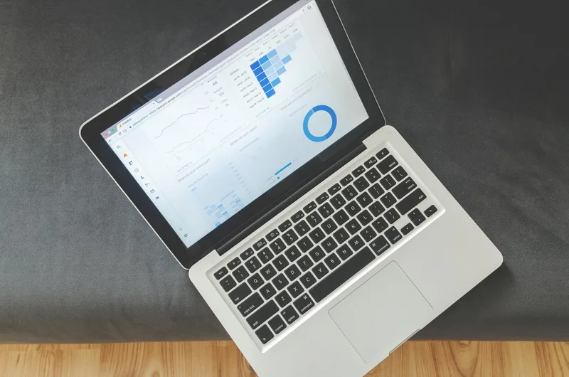 Laptop screen showing data visualizations and analytics charts for tracking newsletter performance
