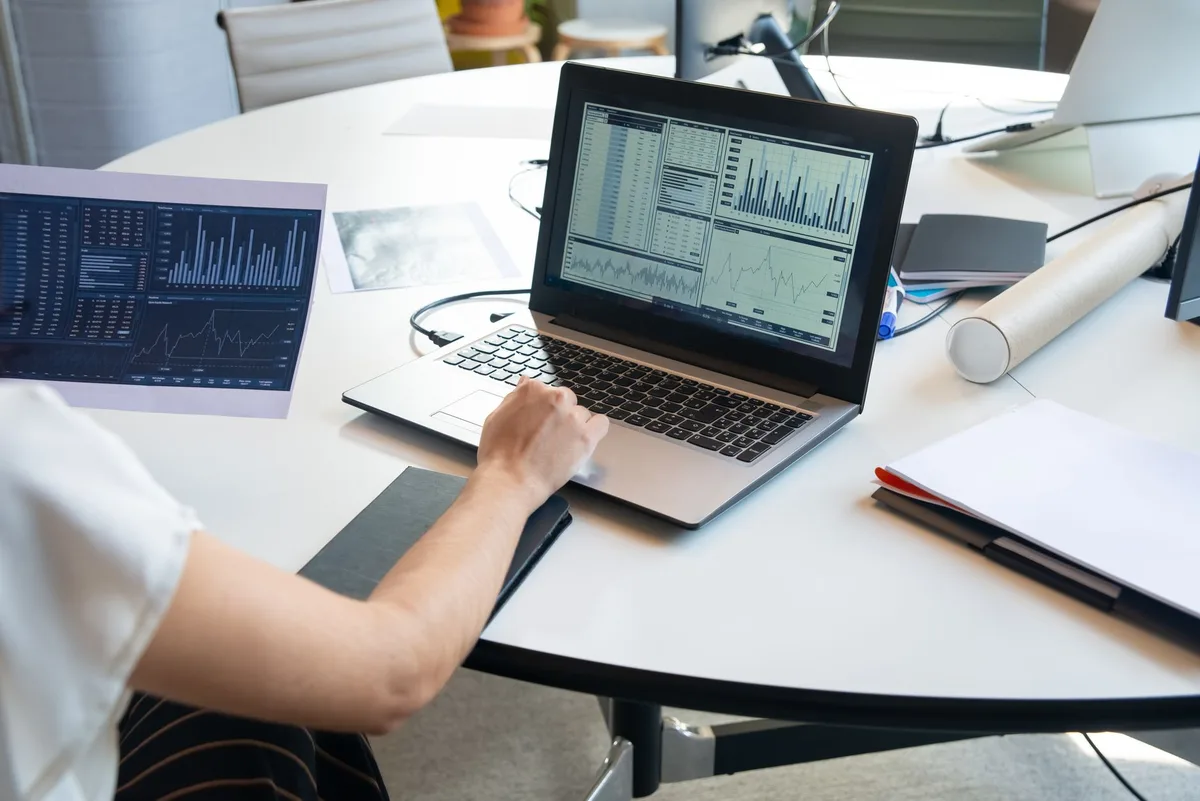 Creator reviewing Twitter analytics on a laptop screen showing impressions data